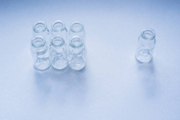 istock glass ampoules on a blue background 1258030706