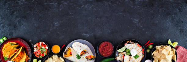 istock Mexican food bottom border, top view on a dark banner background with copy space 1258035588