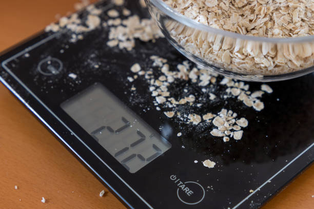 istock black kitchen scale with porridge oats 1258036458