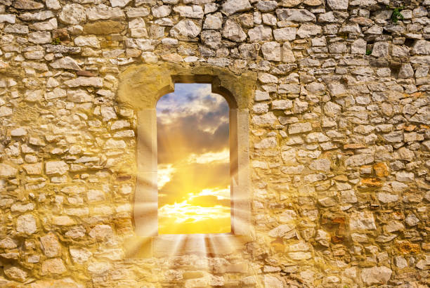 view to a sunset from a window in a old stony wall