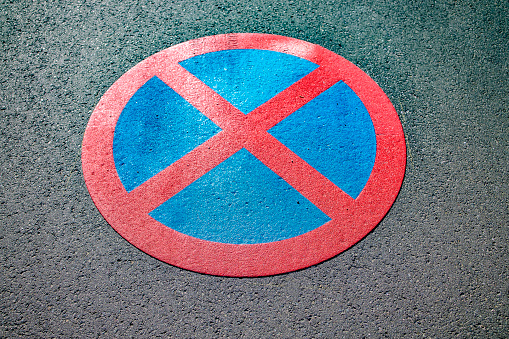No stopping sign on rough asphalt in Detail