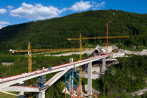 Construction of a high speed train bridge over the valley, aerial view.