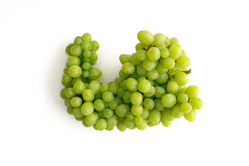 Fresh green grapes with leaves. Isolated on white background