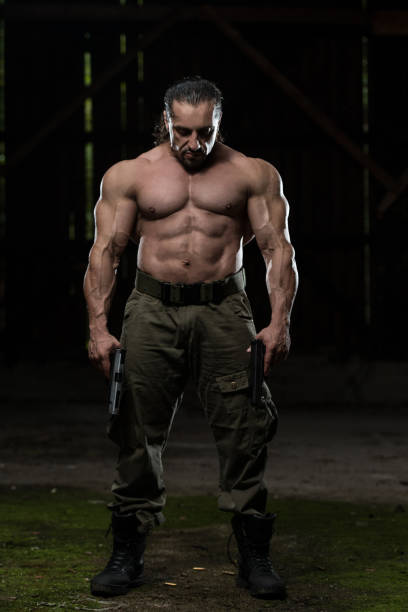 istock Portrait Of A Man With Guns 1258044112