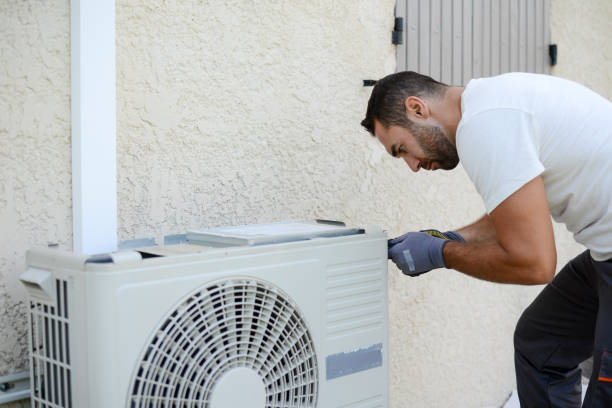 istock handsome young man electrician installing an air conditioning in a client house 1258045042