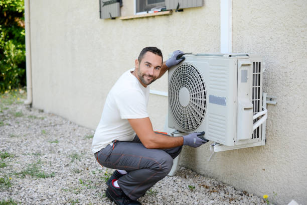 istock handsome young man electrician installing an air conditioning in a client house 1258045045
