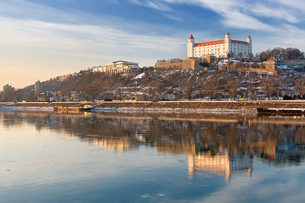 Bratislava Castle and surroundings as seen from the water Bratislava castle with reflection in river Danube  bratislava castle bratislava castle fort stock pictures, royalty-free photos & images