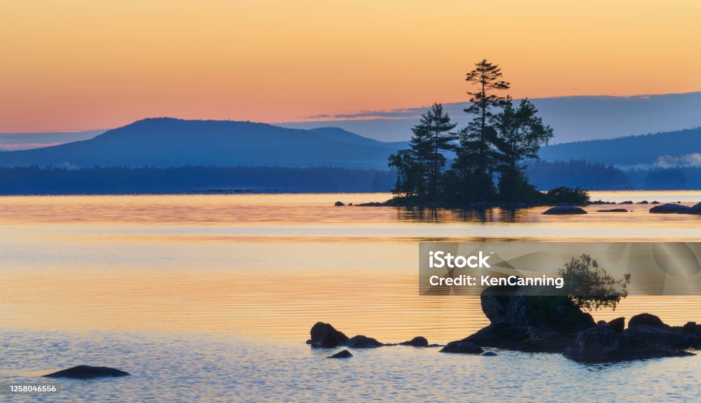 Peaceful Alpine Lake at Sunrise Millinocket Lake with Mt Katahdin in the Background, at Sunrise. Maine Maine Stock Photo