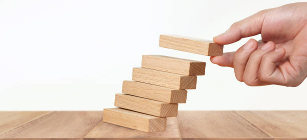 istock Hand arranging wood block stacking as step stair, Business concept growth success process 1258050444