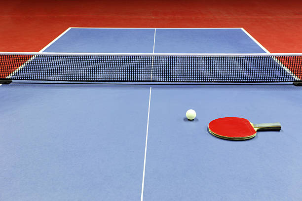 istock Close-up of blue ping pong table with red paddle on top 125805610