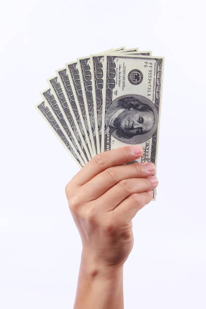 istock Man hand holding money, isolated on white background 1258061086