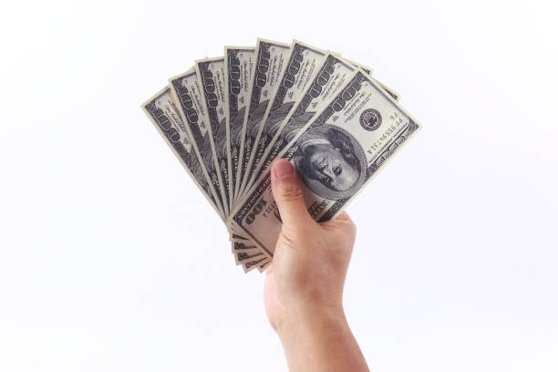 istock Man hand holding money, isolated on white background 1258061089