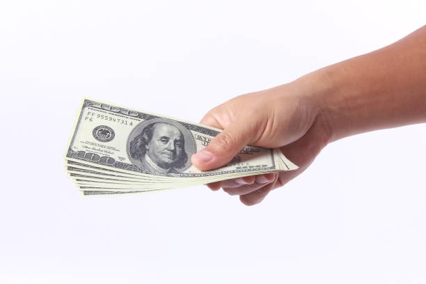istock Man hand holding money, isolated on white background 1258061091
