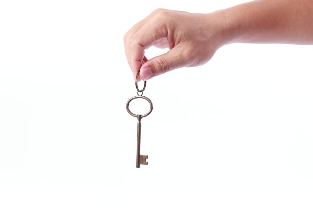 istock Man hand holding success key, isolated on white background 1258061102