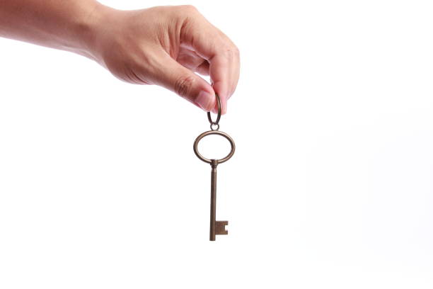 istock Man hand holding success key, isolated on white background 1258061106