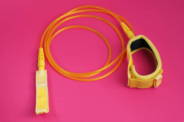 istock Yellow leash for surfboard on red background. 1258061158