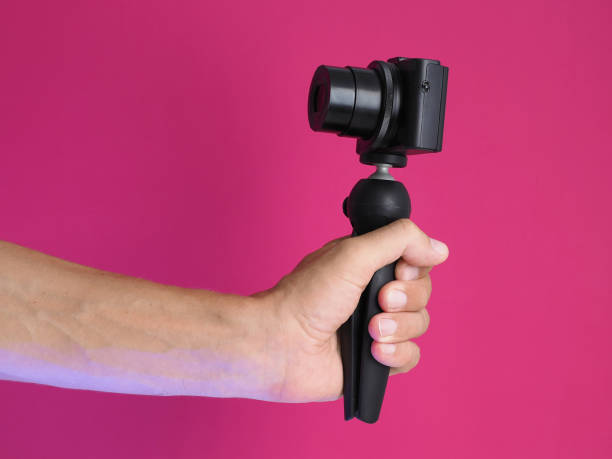 istock Male holding compact camera in hand, making video blog. Close up. 1258063375