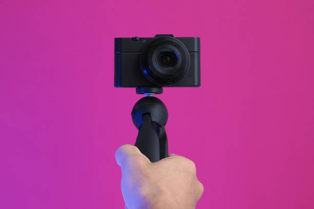 istock Male holding compact camera in hand, making video blog. Close up. 1258063376