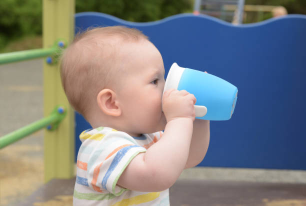 istock Baby with water mug 1258063559