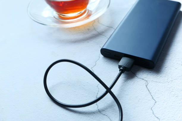 istock Power bank for charging mobile devices on table. 1258064148