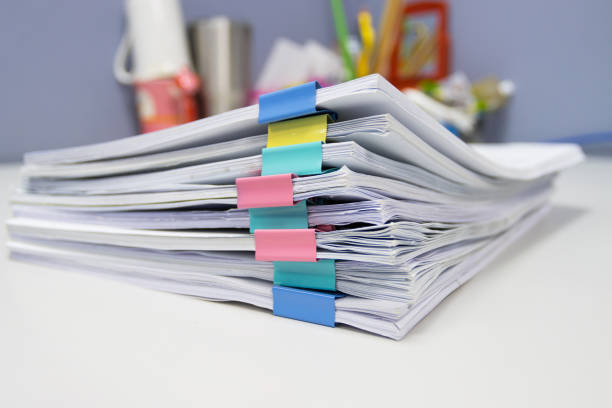 istock file folder and Stack of business report paper file on the table in a work office, concept document in work office 1258067238