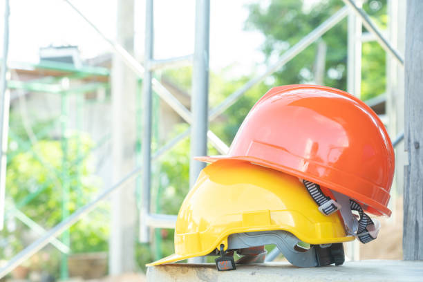 istock Yellow green orange and blue hard safety helmet hat for safety workman. as engineer or worker. 1258068949