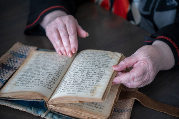 istock Mature woman reading ancient analogue book in Hebrew. 1258071754