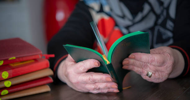 istock Mature woman reading analogue book. 1258071818