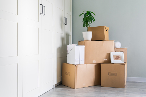 Things are prepared for moving, Packed in cardboard boxes, copy space. Cardboard boxes are waiting to be delivered to your new home. Advertising a neat and careful delivery service.