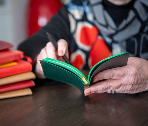 istock Mature woman reading analogue book. 1258072742