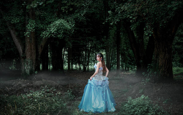 a  beautiful teenage girl in a silk skirt and a corset in the old money style walks in the park and along the river bank