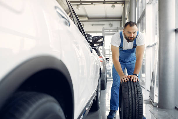 istock Handsome man in a blue uniform checks the car 1258075457