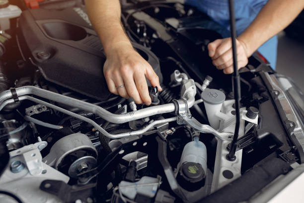 istock Handsome man in a blue uniform checks the car 1258075661