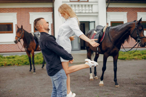 istock Cute loving couple with horse on ranch 1258076296