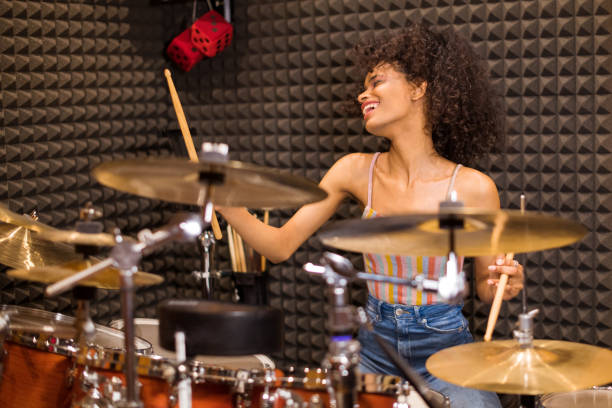 istock Young black female drummer in a recording studio 1258077318