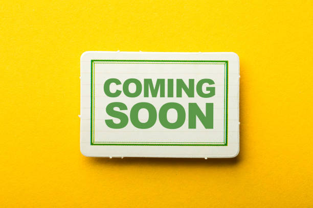 istock Coming Soon Label On Yellow Background 1258078307