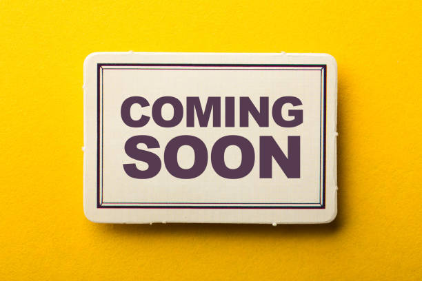 istock Coming Soon Label On Yellow Background 1258078308