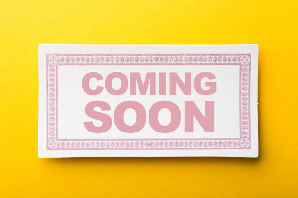 istock Coming Soon Label On Yellow Background 1258078311