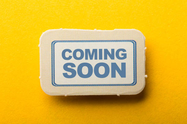 istock Coming Soon Label On Yellow Background 1258078318