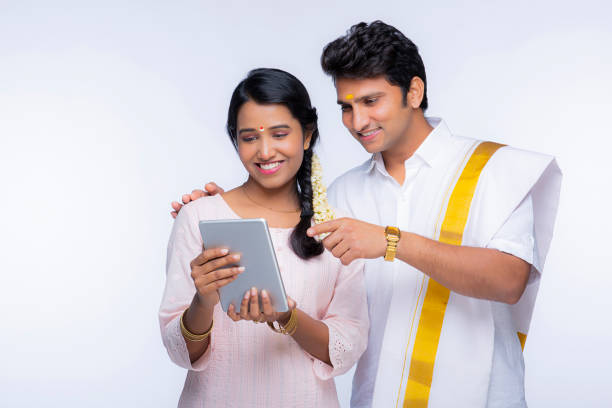 Young South Indian couple - stock photo Indian Ethnicity, Indian culture, India, tradition, Young couple, White background south indian lady stock pictures, royalty-free photos & images
