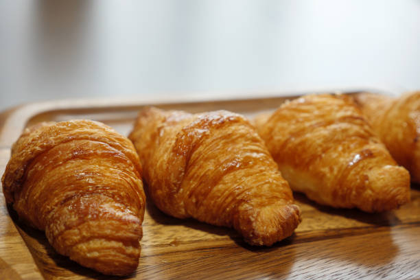 istock Glossy croissants lined up on a cutting board 1258081748
