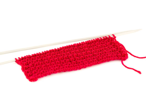 istock Red yarn with knitting needles 1258082316