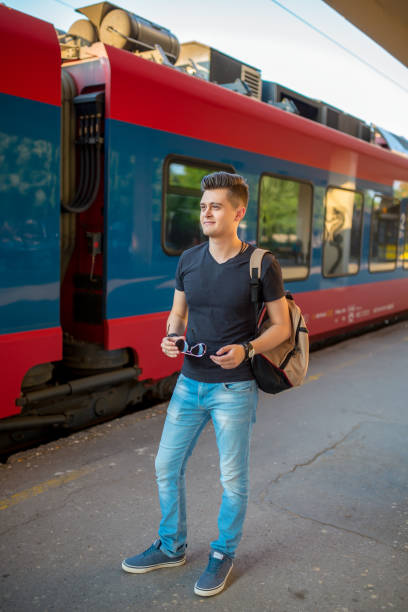 istock Man standing on the subway platform, waiting for his train. 1258082590