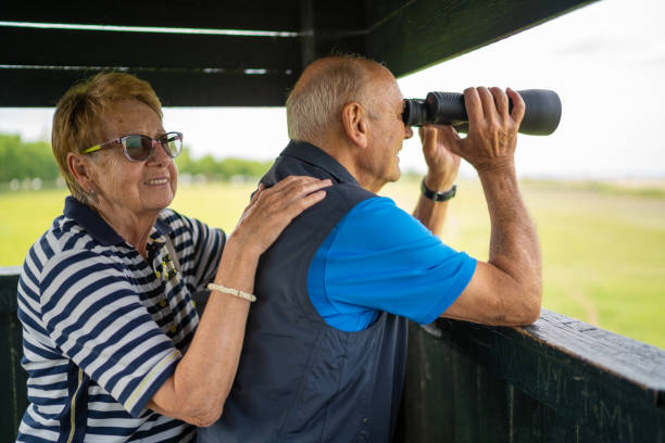 istock senior couple watching wildlife from observation point 1258084338
