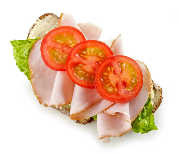 slice of bread with ham and tomato isolated on white background, top view