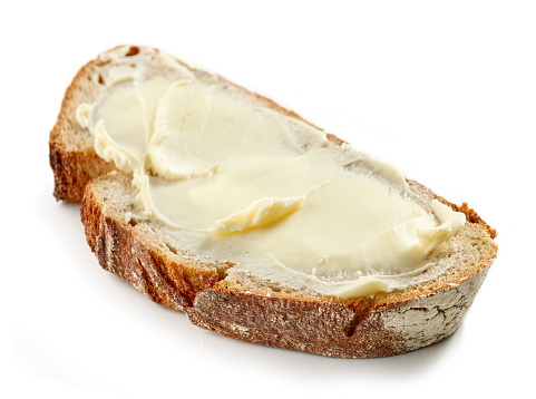 slice of bread with butter isolated on white background