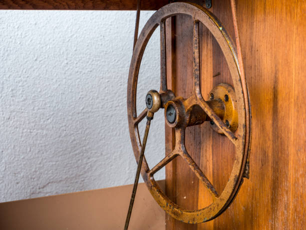 Close up detail with a iron treadle base sewing machine .