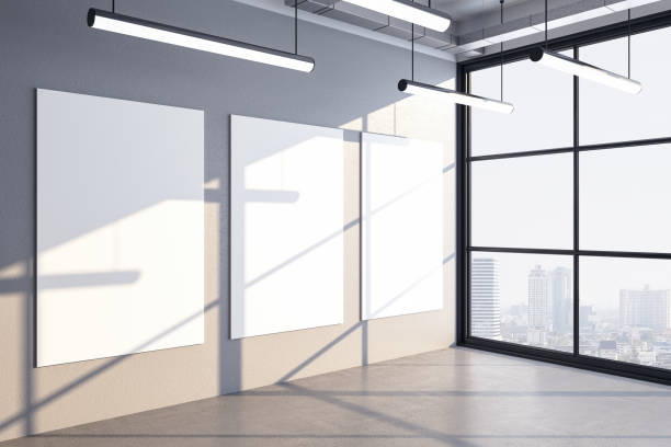 istock Luxury office hall interior with three blank posters on wall 1258091874