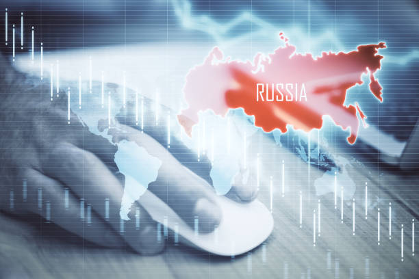 istock Businessman hand using computer mouse with map of Russia and falling chart 1258091997