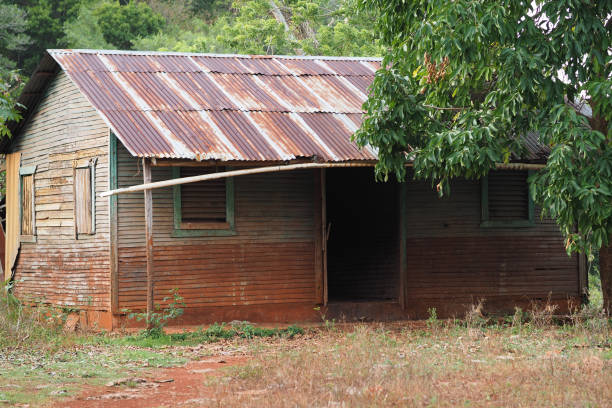 istock Side view. Old Abandoned Wooden House With rusted roof. 1258093769